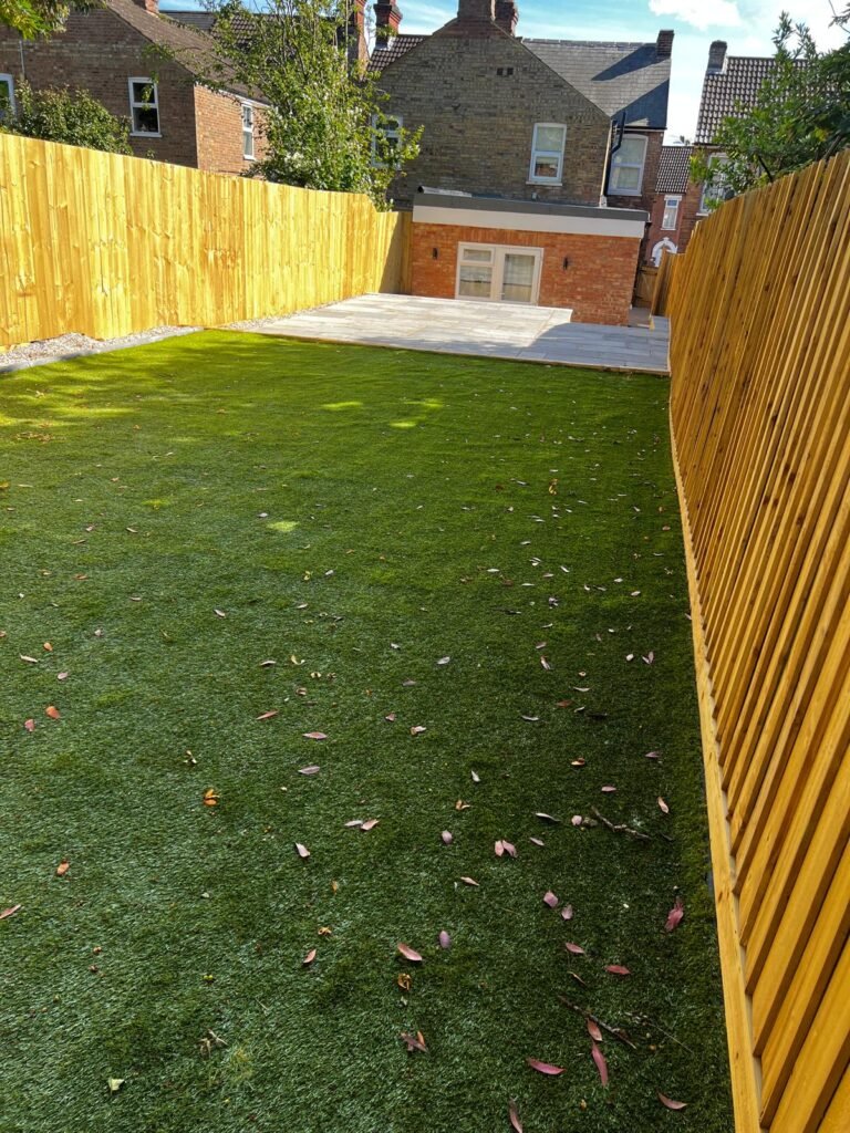Landscaped garden with paving and artificial grass in Ipswich