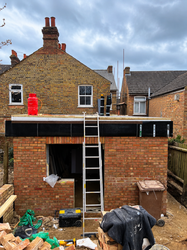 Brick-built rear extension during flat roof installation in Ipswich